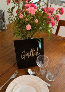 a table with a vase of pink flowers on a table at Villa Margit ground floor apartment in Tvååker