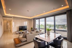 a living room with a couch and a table at Sky Suites-KASS Towers in Okponglo