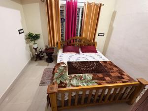 a bedroom with a wooden bed in a room at Swasthiks Home stay in Sakleshpur