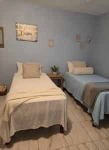 two beds sitting next to each other in a room at Private Villa Paradise - Pool & Mountain Views in Top Hill