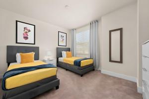 a bedroom with two beds and a window at Cozy 3bd 3bath @HiddenForest with pool in Orlando +29 photos