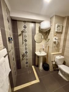 a bathroom with a toilet and a sink at Bianchi Hotel in Alexandria +117 photos