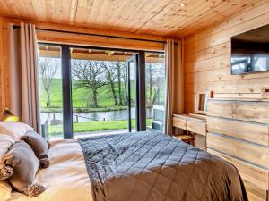 a bedroom with a bed and a large window at 3 Bed in Cullompton 94139 in Cullompton