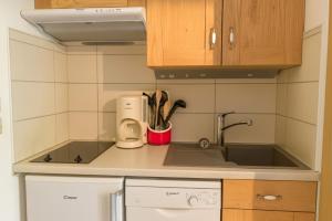 a small kitchen with a sink and a counter at Vue Des "Chavants" Studio 20 M With Balcony in Les Houches