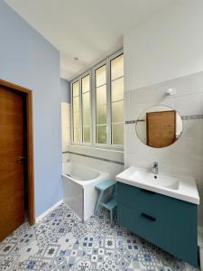 a bathroom with a sink and a tub and a mirror at Résidence Bonnecaze in Eaux-Bonnes +36 photos