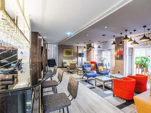 a lobby with colorful chairs and tables in a building at ibis Styles Chaves in Chaves