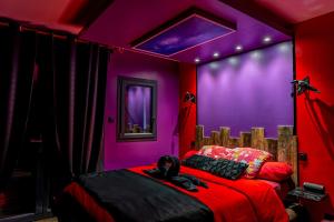 Dormitorio púrpura con 2 camas en Love Room La Magie d'une Nuit, en Agde