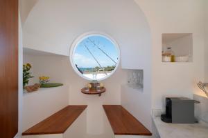 a room with a round window and a wooden bench at Lanzarote Famara Beach Bungalow in Famara