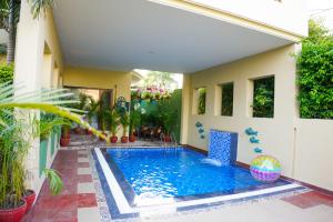 a swimming pool in the backyard of a house at Marigold House in Amritsar