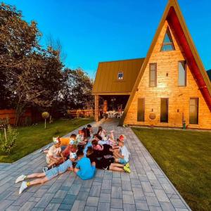 a group of children laying on the ground in front of a church at Shurra in Cheia
