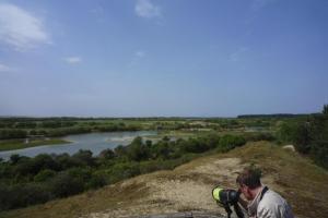 a man taking a picture of a river with a camera at Semi-detached house, Rieux in Rieux