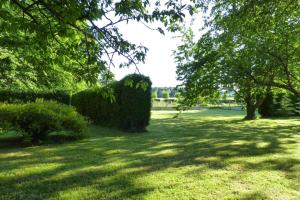 a park with bushes and trees in a field at Semi-detached house, Rieux in Rieux +48 photos