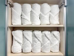 a bunch of white towels in a closet at Oknuri in Seoul