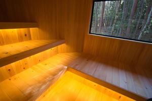 an empty room with a window and wooden floor at FujiSaunaVillage グランピングテント in Fujikawaguchiko