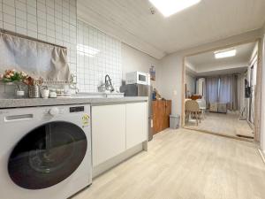 a kitchen with a washing machine in a kitchen at Oknuri in Seoul +25 photos