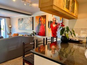 a kitchen with a counter top in a living room at Spinnaker Quays Waterfront Villa in Knysna