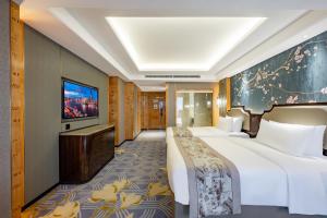 a hotel room with a bed and a flat screen tv at 上海浦天美泊酒店 in Shanghai