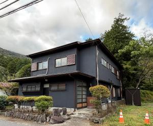 a black house with an orange cone in front of it at 雲の家 旧東海道沿いの畑宿の温もりステイ in Hakone