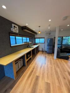 a large living room with a desk and a couch at 雲の家 旧東海道沿いの畑宿の温もりステイ in Hakone +11 photos