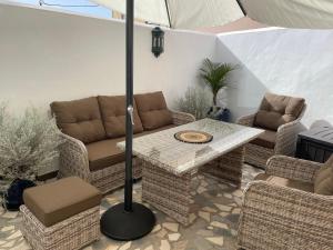 a patio with a table and chairs and an umbrella at Casita Ricarda in Tazacorte