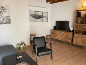a living room with a chair and a television at Casita Ricarda in Tazacorte