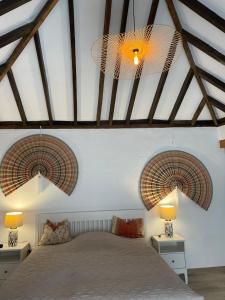 a bedroom with two chandeliers and a bed at Casita Ricarda in Tazacorte