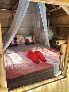 two red pillows on a bed in a tent at Lanta Rabbit Rooms in Ko Lanta +84 photos