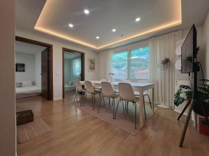 a dining room with a table and chairs at More Than a Stay in Suwon