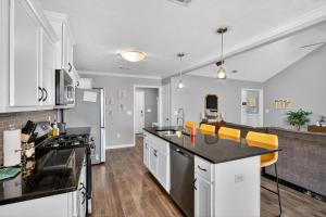 a kitchen with white cabinets and black counter tops at Peaceful Family Retreat Near Augusta home in Warrenville
