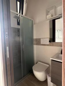 a bathroom with a toilet and a glass shower at Il Nido Di Francesco Tourist Rental in Spinoso