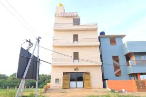 a building with a lighthouse on top of it at Magesh Residency in Jāmb