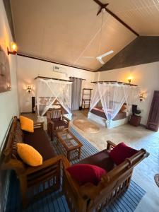 an aerial view of a living room with a couch and a bed at Emma's Sea View in Hiriketiya