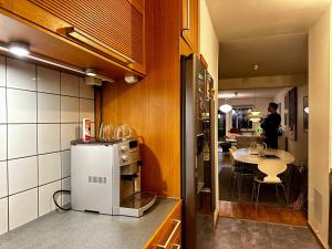 a kitchen with a counter and a table in a room at Spacious Apartment in Sodermalm in Stockholm