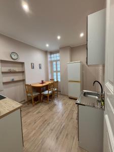a kitchen and dining room with a table and chairs at 100 Éves Ház in Esztergom