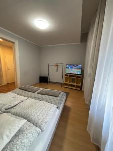 a bedroom with a bed and a flat screen tv at 100 Éves Ház in Esztergom