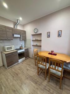 a kitchen and dining room with a wooden table and chairs at 100 Éves Ház in Esztergom +6 photos