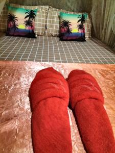 a pair of red slippers on the floor next to a couch at Lanta Rabbit Rooms in Ko Lanta