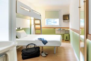 Postel nebo postele na pokoji v ubytování ibis budget Metz Sud