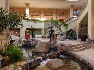 a building with a pond with statues of people in it at Naama Bay Promenade Beach Resort Managed By Accor in Sharm El Sheikh