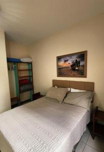 ピニェイラにあるPartiu Praia SC- Piscina, Ar condicionado, wi-fi, duas quadras da praia e centrinhoのベッドと壁に絵が飾られた寝室 +41枚の写真