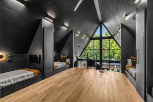 ein Schlafzimmer mit zwei Betten und einem großen Fenster in der Unterkunft Midnight Raven Lake House - luxury a-frame w boat in Reed Creek
