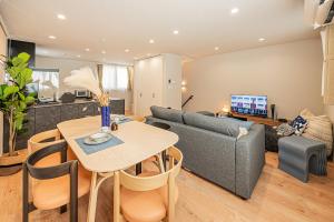 a living room with a couch and a table at Mi-Villa SHIBUYA HONMACHI in Tokyo