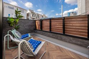 a balcony with two chairs and a table at Mi-Villa SHIBUYA HONMACHI in Tokyo