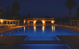 a large swimming pool at night with a building at Complexe Touristique Sidi Salem in Bizerte