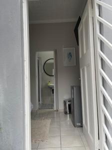 a hallway leading to a bathroom with a mirror at Lani Accommodation in Pretoria