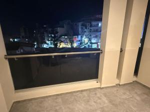 a window with a view of a city at night at Résidence montana in Deli Ibrahim