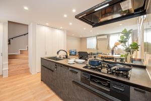 a kitchen with a sink and a stove top oven at Mi-Villa SHIBUYA HONMACHI in Tokyo