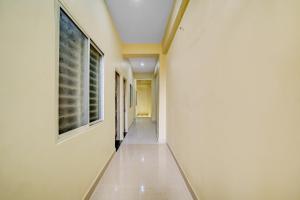 an empty hallway in a building with a window at Hotel O Home Trimurti guest house in Guwahati