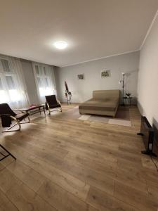 a large room with a bed and chairs in it at 100 Éves Ház in Esztergom