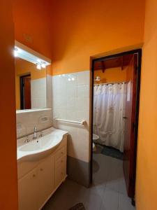 a bathroom with a sink and a tub and a shower at Casa con Pileta a Cuadras de la Playa in Paso de la Patria